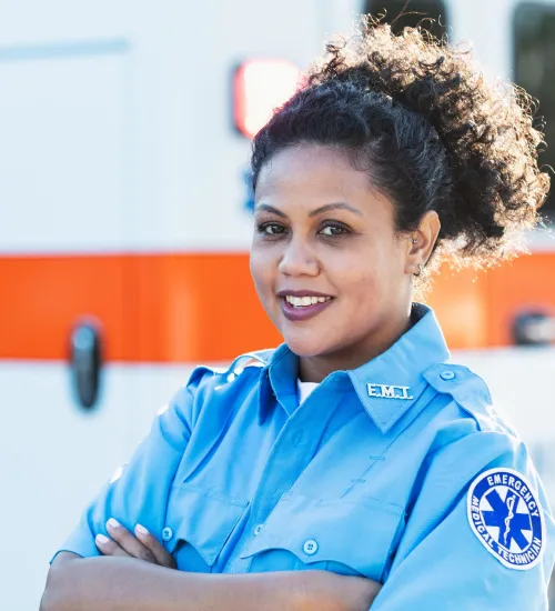 paramedic posed in front on ambulance